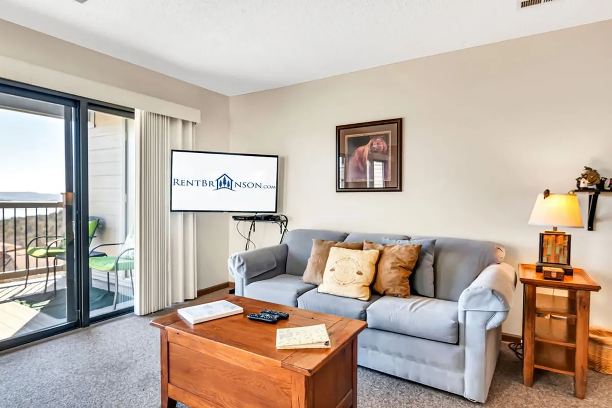 A cozy living room scene with a comfortable sofa, coffee table, soft lighting, and a large television. The space invites relaxation, socializing, and movie nights, providing a glimpse of the inviting interior waiting after a day of adventures.